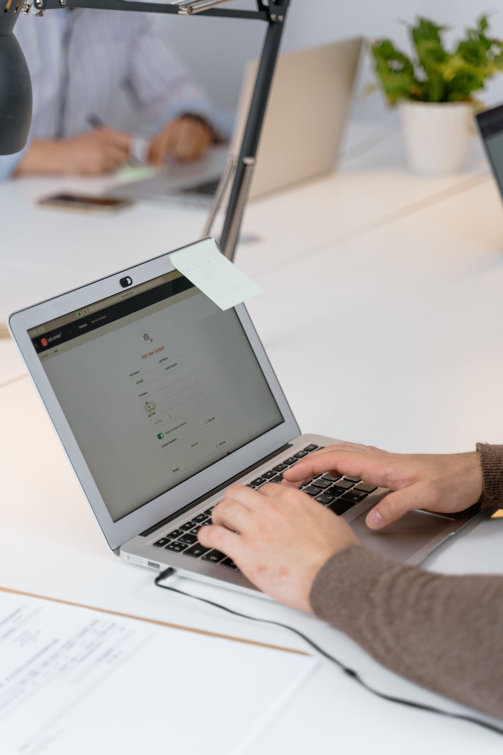 Guy sitting with computer and note